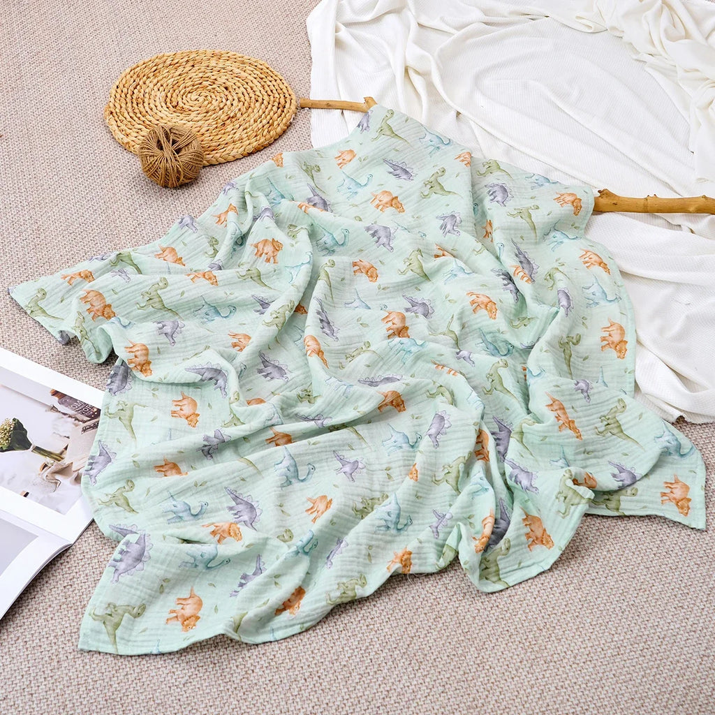 Lange bébé en mousseline de coton motif dinosaures menthe