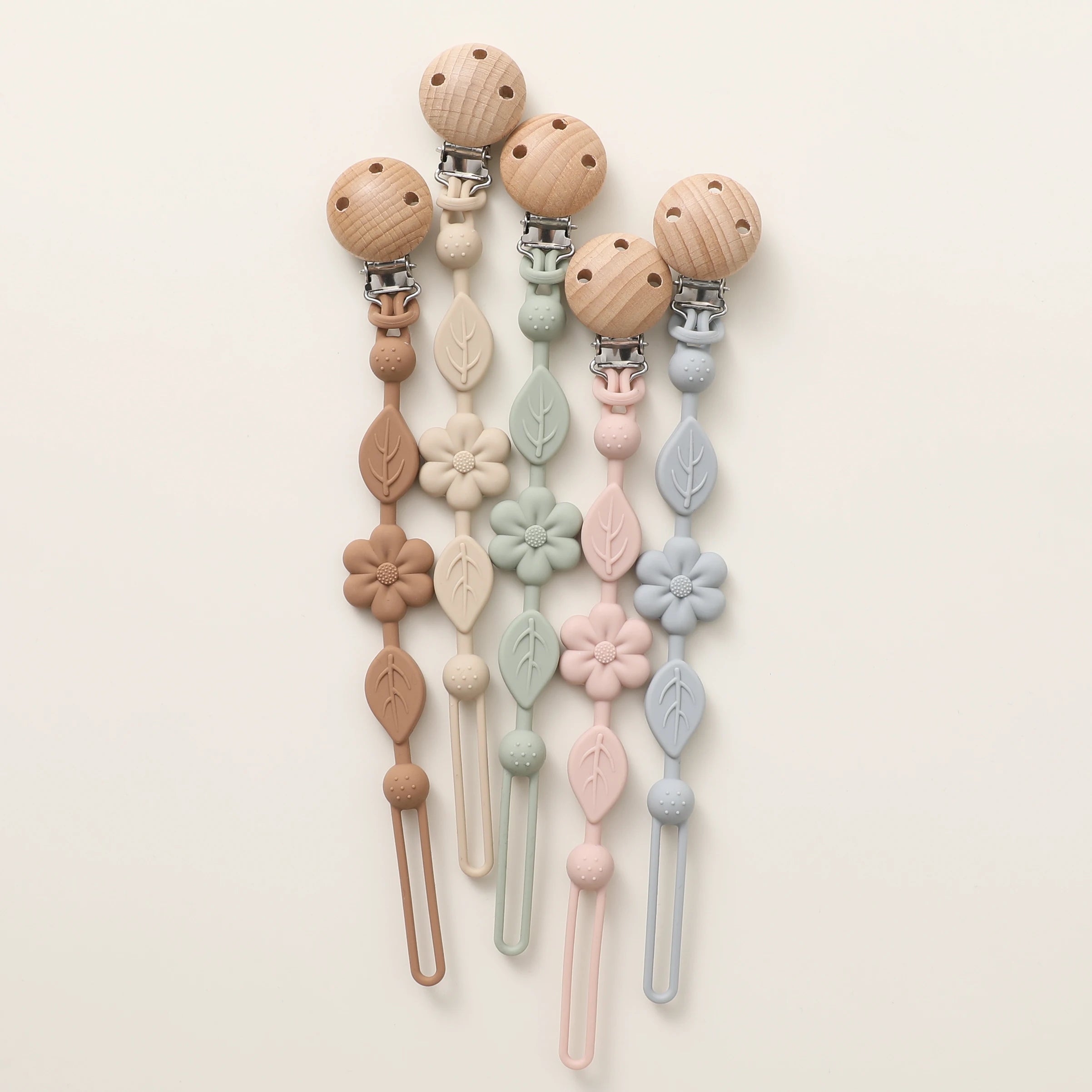 Attaches-tétine fleur en silicone disponibles en quatre couleurs