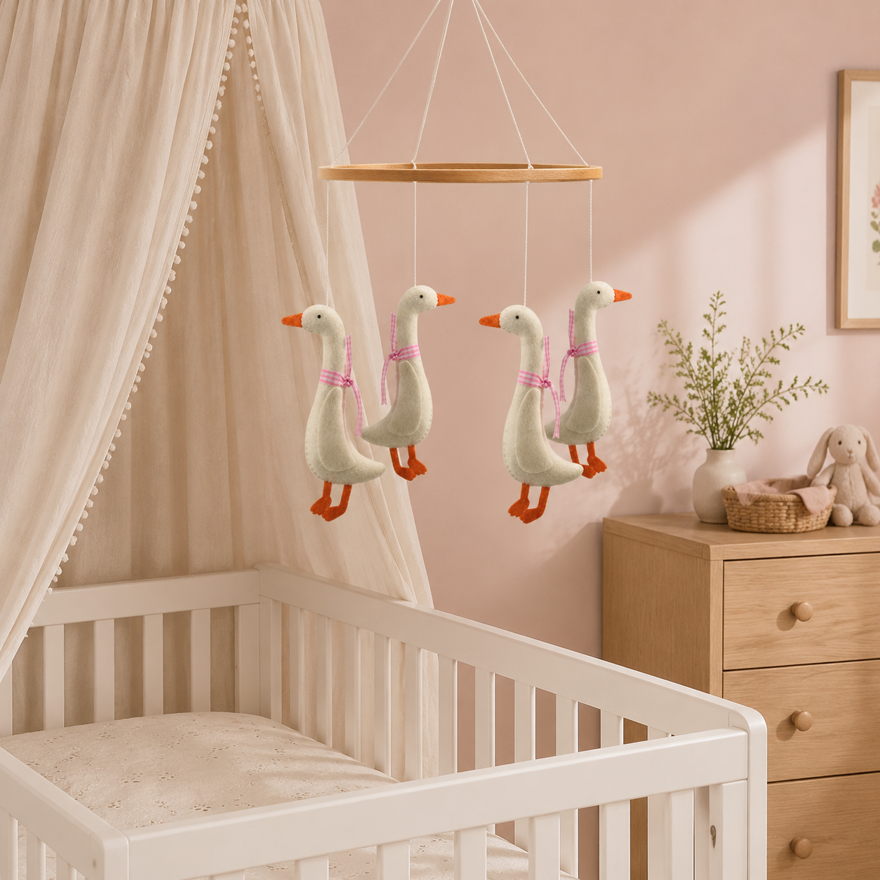 Mobile oies à rubans roses dans une chambre de bébé