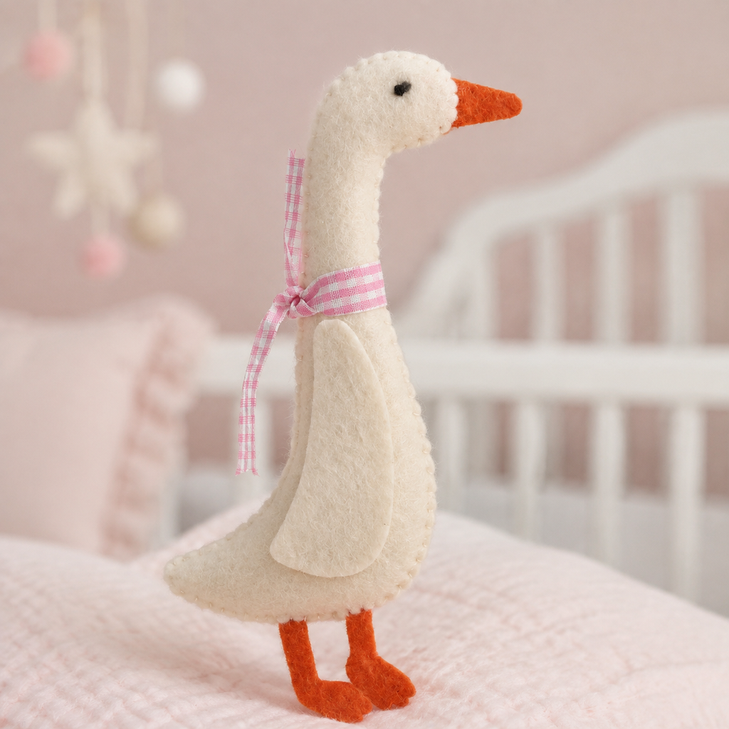Détail d’une oie en feutrine avec ruban rose